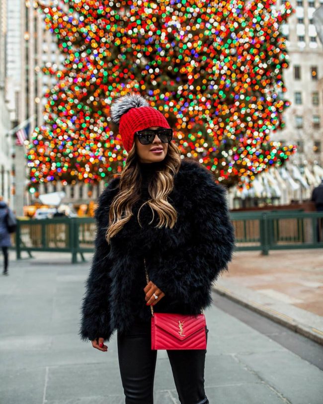 fashion blogger mia mia mine wearing a feather jacket by bcbg in new york city for chrisrtmas 2018