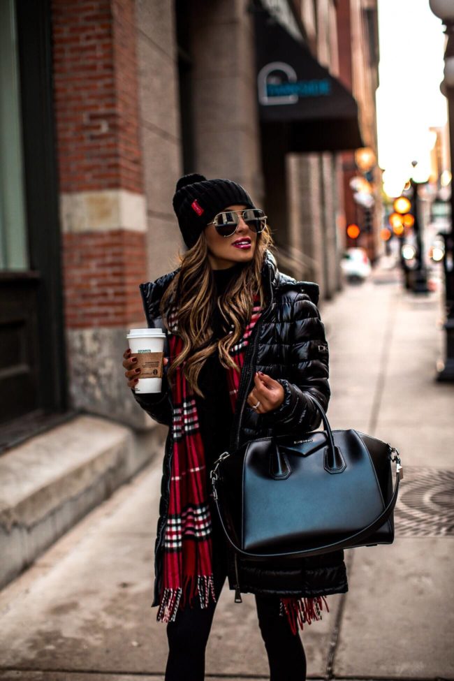 fashion blogger mia mia mine wearing a puffer jacket from walmart and a givenchy bag