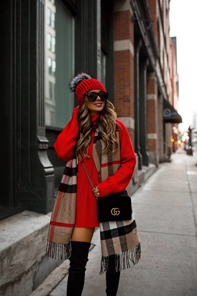 fashion blogger mia mia mine wearing a red sweater dress from revolve and a burberry scarf with a gucci velvet bag for winter 2018