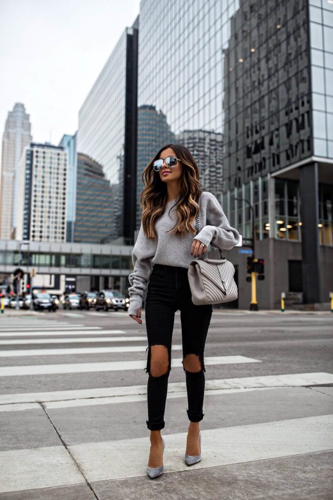 fashion blogger mia mia mine wearing a gray intermix sweater and black mango denim