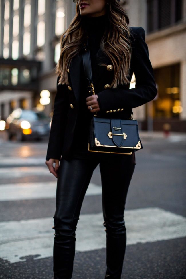 fashion blogger mia mia mine wearing faux leather pants and a prada cahier bag