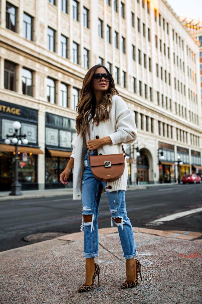 fashion blogger mia mia mine wearing grlfrnd denim and a white lovers + friends cardigan from revovle