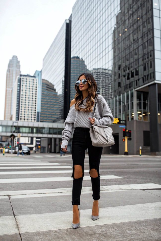 fashion blogger mia mia mine wearing a gray off-the-shoulder sweater and gianvito rossi suede heels with a gray saint laurent bag