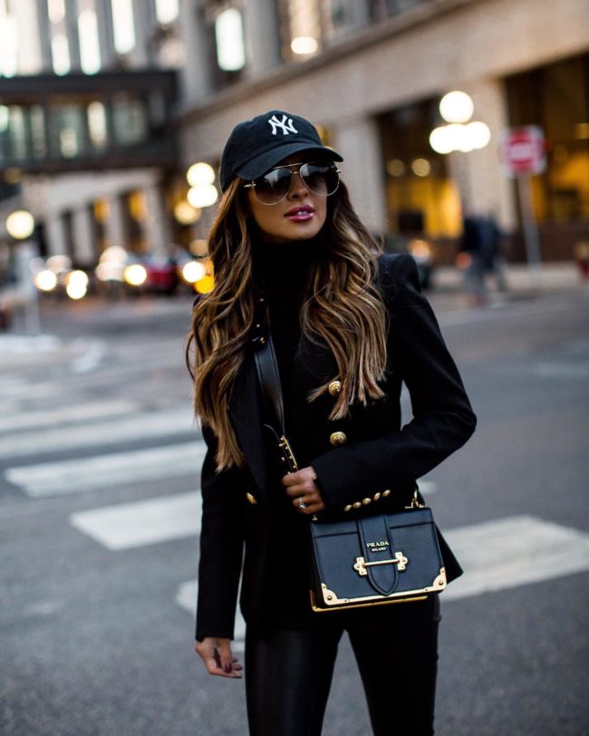 fashion blogger mia mia mine wearing a balmain blazer and a new york yankees hat