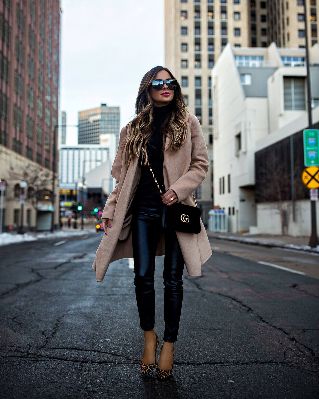 fashion blogger mia mia mine wearing a camel coat and black faux leather blank denim pants from shopbop with christian louboutin leopard calf hair pumps