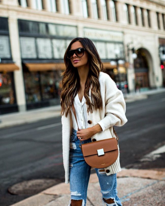 fashion blogger mia mia mine wearing a cozy cardigan from revolve and a demellier bag