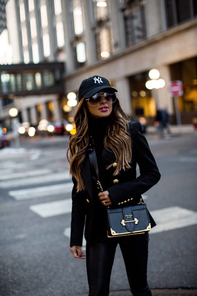 fashion blogger mia mia mine wearing a prada cahier bag and a ny cap