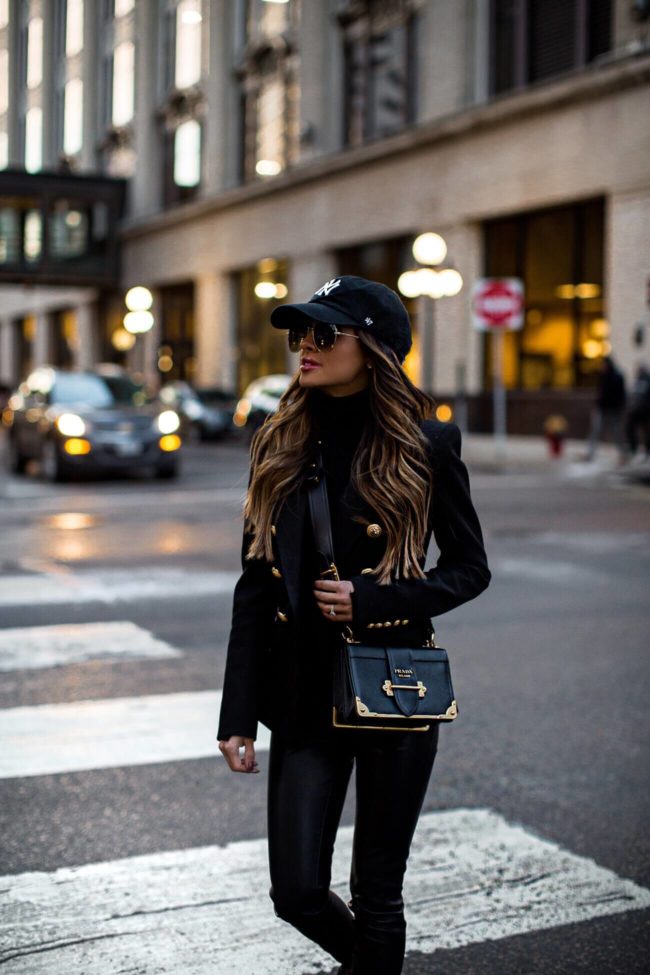 fashion blogger mia mia mine wearing an ny baseball cap and a balmain blazer