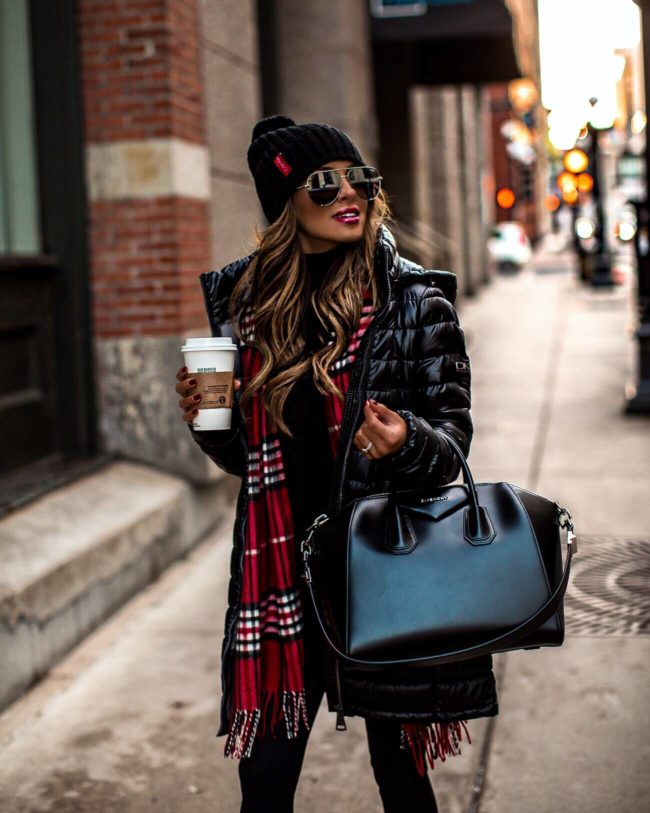 fashion blogger mia mia mine wearing a black puffer coat and a red plaid scarf for winter with a givenchy antigona bag