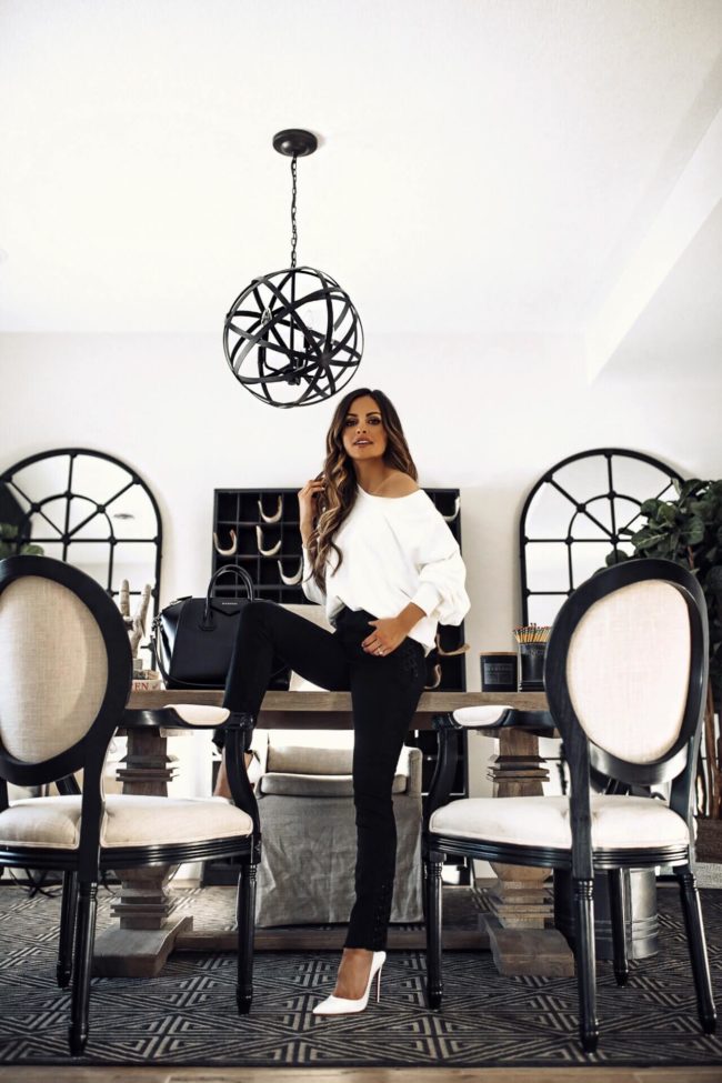 fashion blogger mia mia mine wearing a white sofia vergara sweatshirt and black denim from walmart