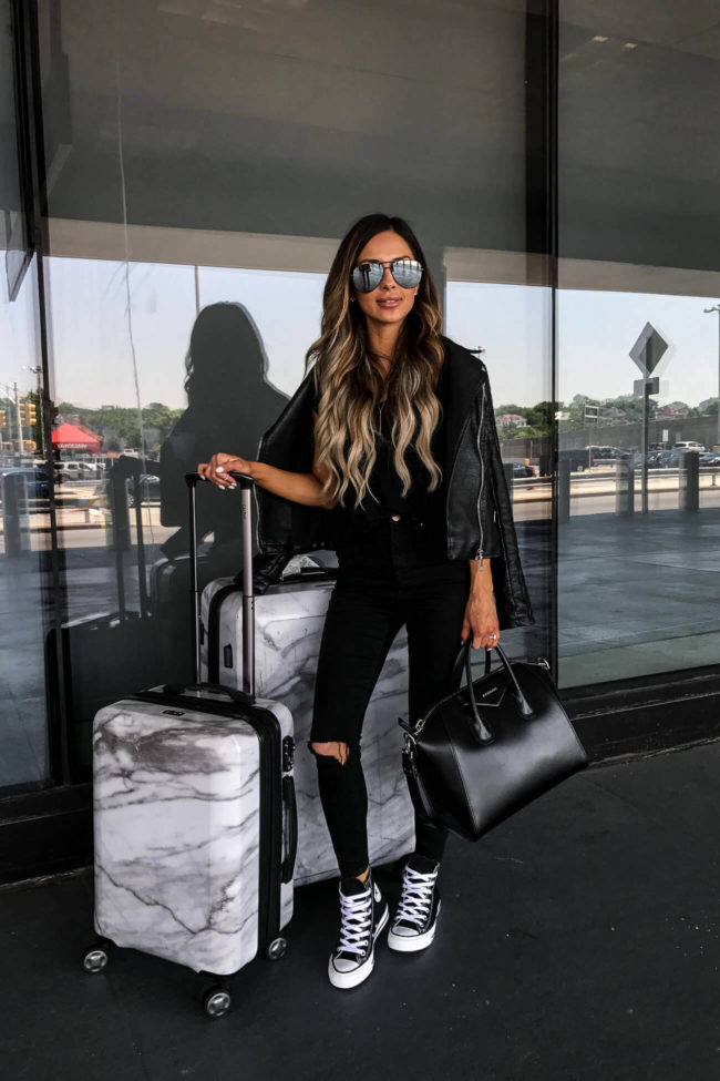 fashion blogger mia mia mine with calpak marble luggage and a givenchy bag