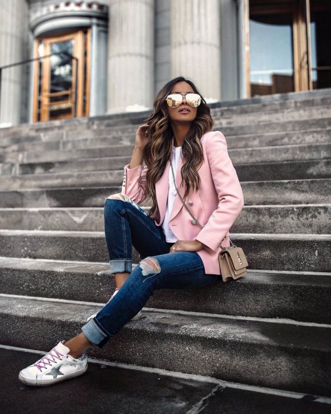 fashion blogger mia mia mine wearing a pink blazer and golden goose sneakers from intermix