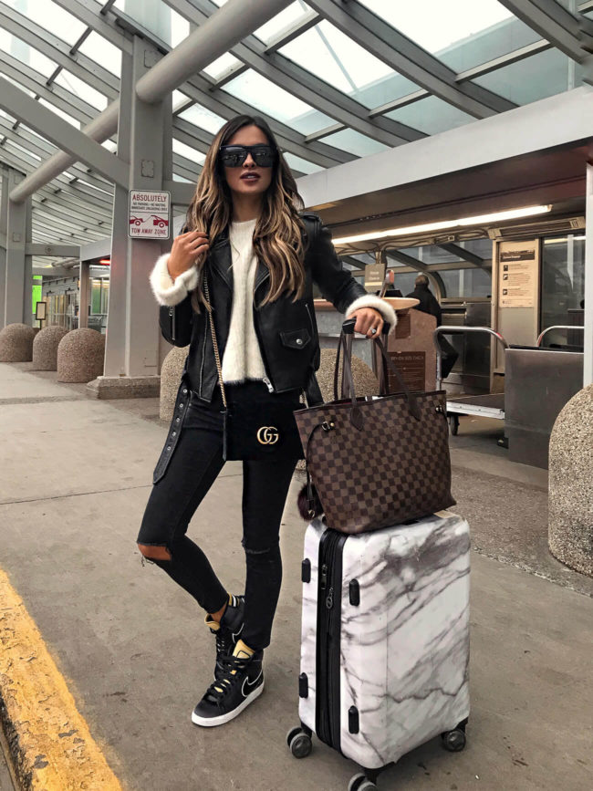 fashion blogger mia mia mine wearing nike sneakers and a louis vuitton neverfull mm