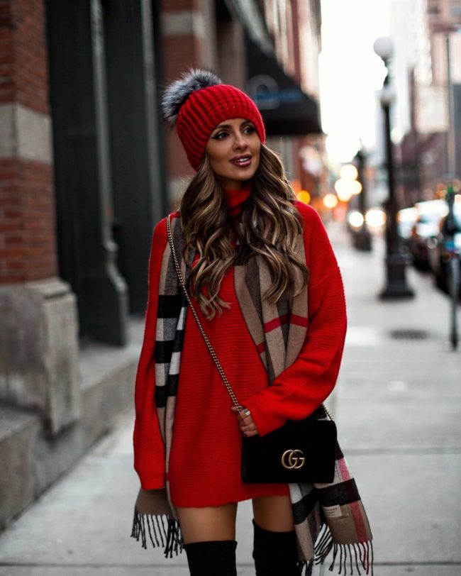 fashion blogger mia mia mine wearing a red sweater dress from revolve with a burberry scarf