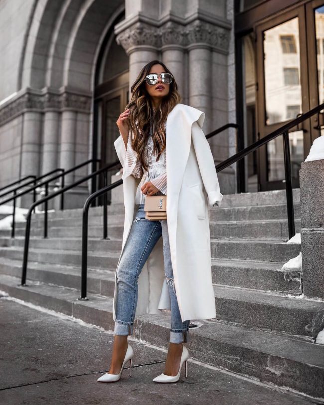 fashion blogger mia mia mine wearing a white coat and white christian louboutin heels
