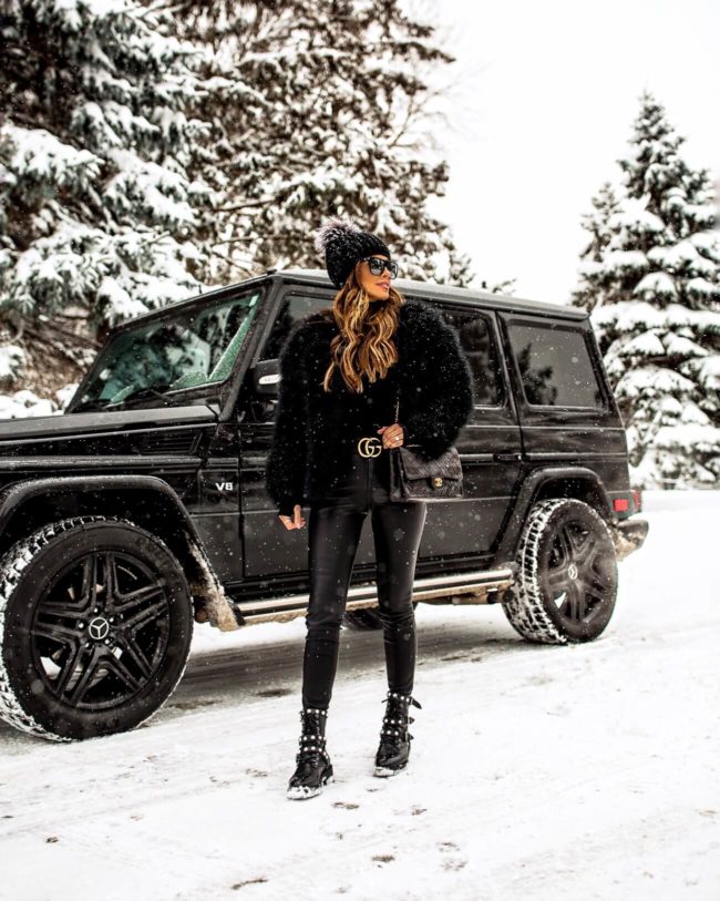 fashion blogger mia mia mine wearing an all black outfit in the winter with a gucci belt 2019