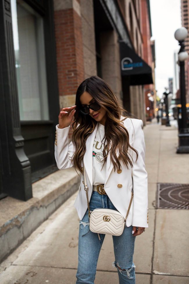 fashion blogger mia mia mine wearing a balmain blazer and a gucci belt from mytheresa