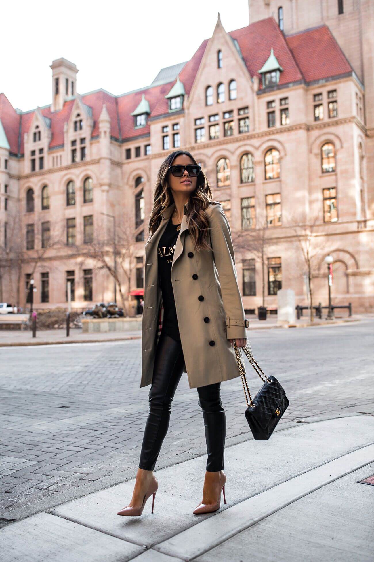 fashion blogger mia mia mine wearing faux leather leggings and a chanel bag