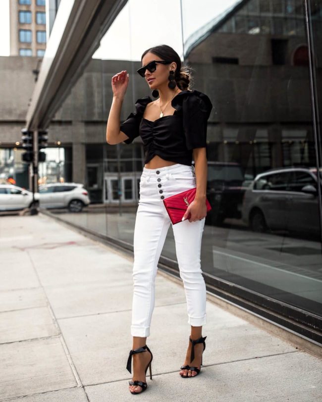 fashion blogger mia mia mine wearing a black crop top and white denim from vici dolld