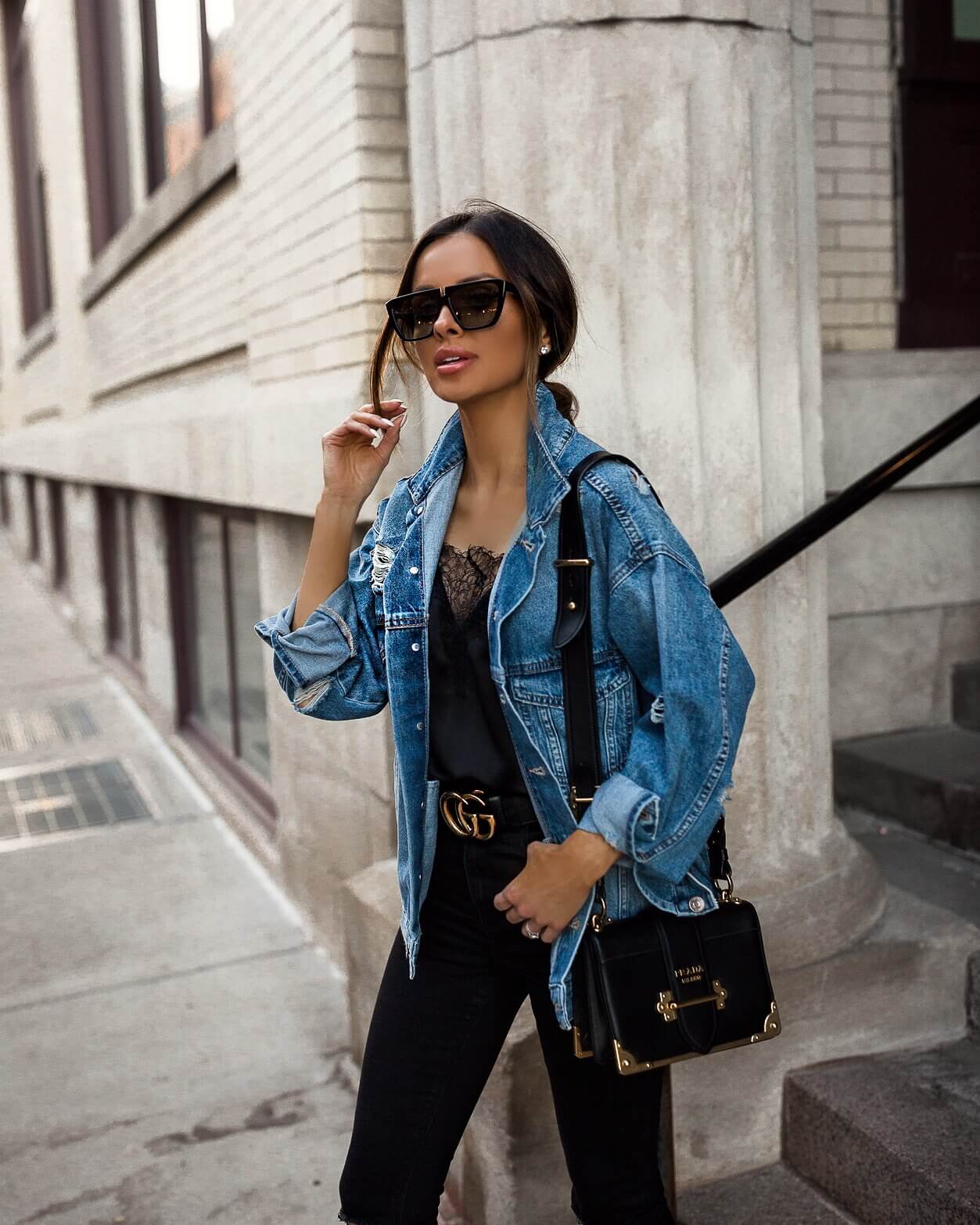 fashion blogger mia mia mine wearing a denim jacket and gucci belt for spring 2019