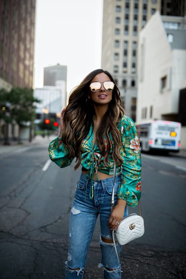 fashion blogger mia mia mine wearing a floral crop top from revolve