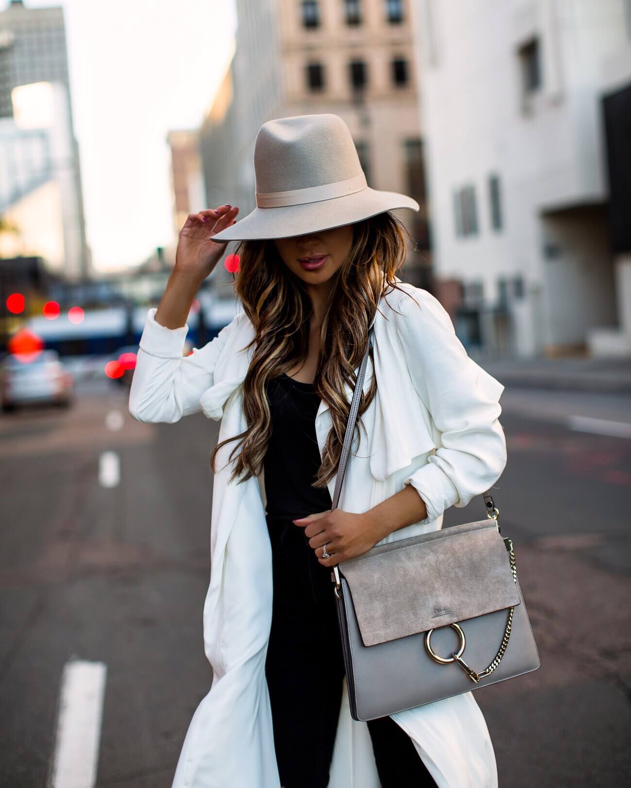 fashion blogger mia mia mine wearing a white trench coat from revolve