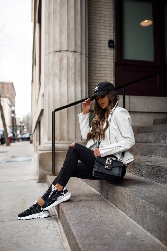 fashion blogger mia mia mine wearing an adidas baseball hat and adidas nite jogger sneakers