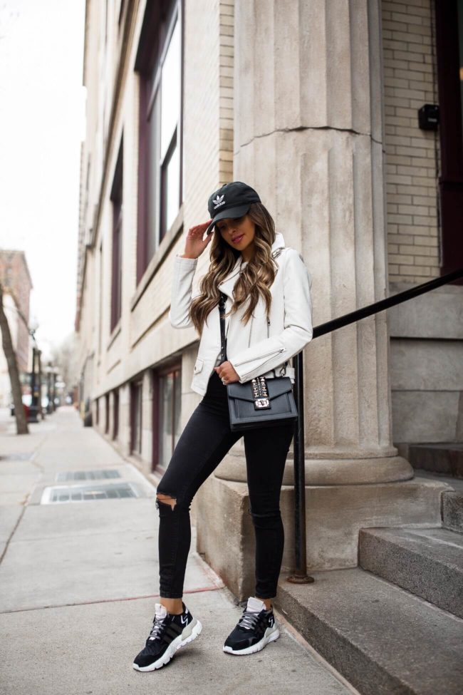 fashion blogger mia mia mine wearing a white leather jacket and adidas nite joggers from finish line
