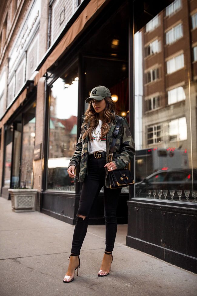 fashion blogger mia mia mine wearing a camo jacket and a gucci belt