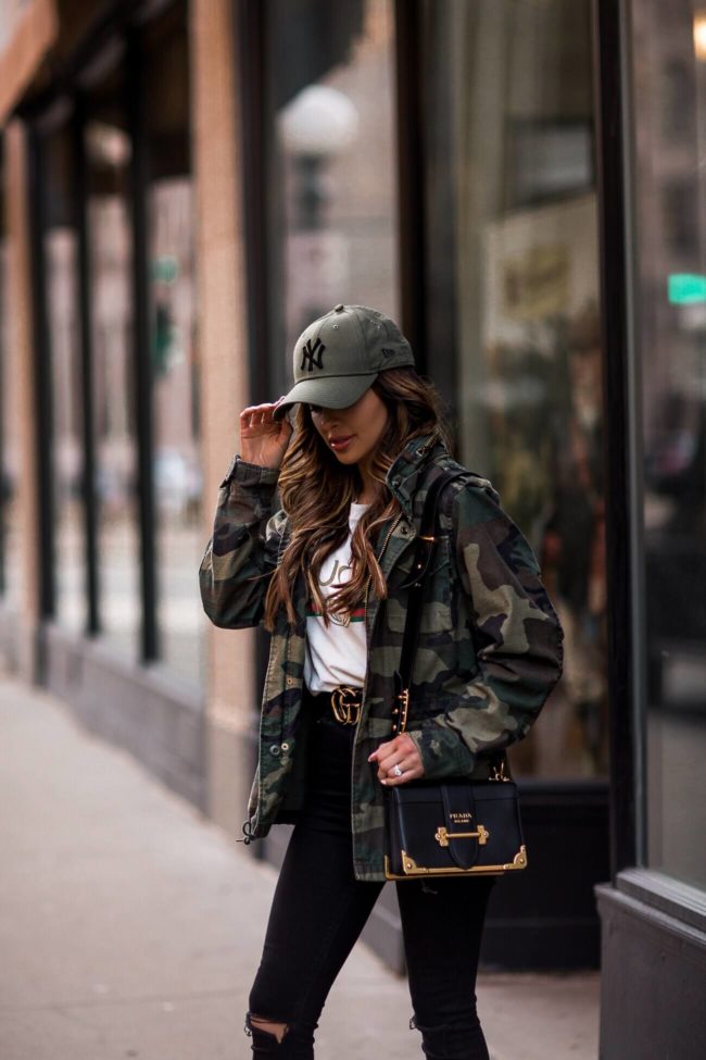 fashion blogger mia mia mine wearing a ny yankees cap and a prada cahier bag