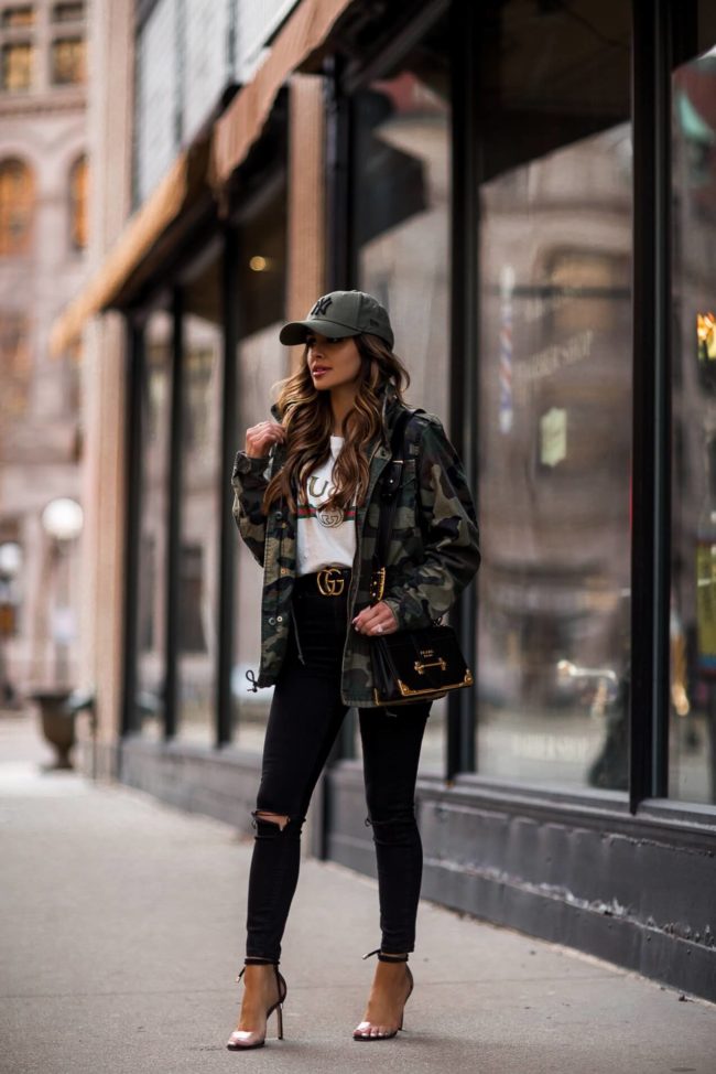 fashion blogger mia mia mine wearing a gucci tee and a prada cahier bag