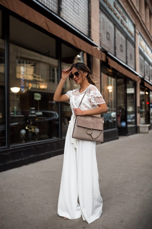 fashion blogger mia mia mine wearing a lace top and white bcbg trousers