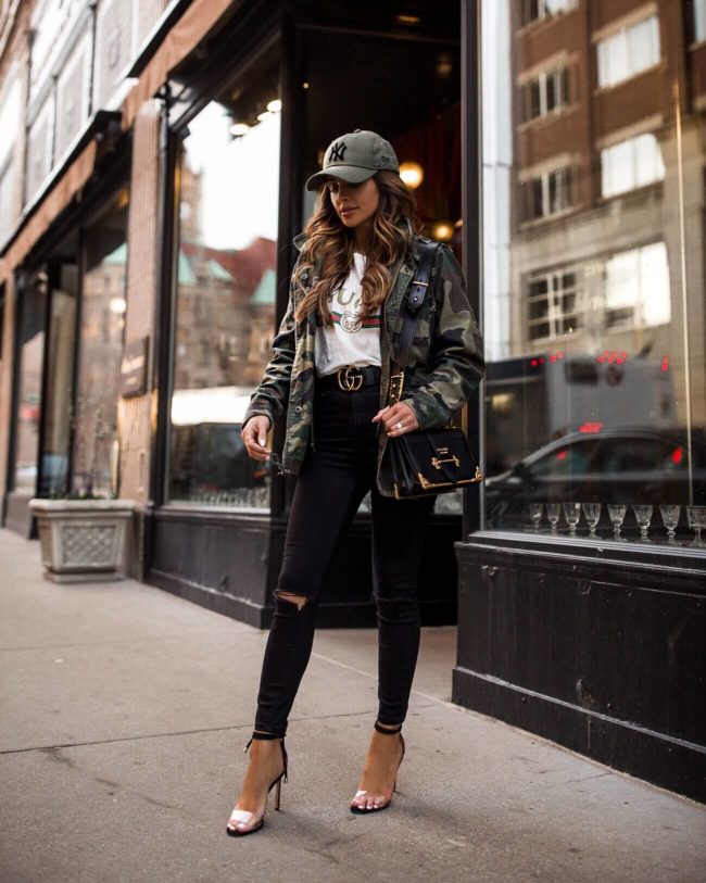fashion blogger mia mia mine wearing a camo jacket and a gucci tee
