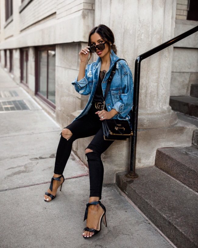 fashion blogger mia mia mine wearing a denim jacket and a prada bag