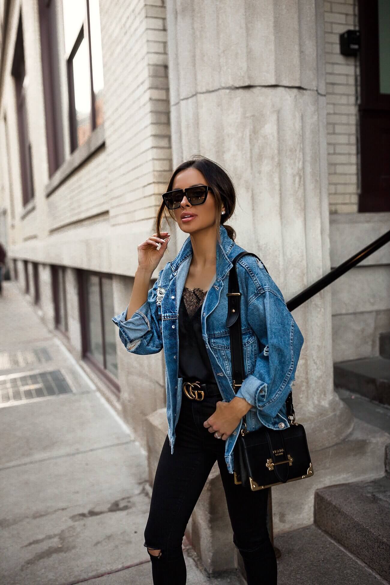 fashion blogger mia mia mine wearing a denim jacket and gucci belt
