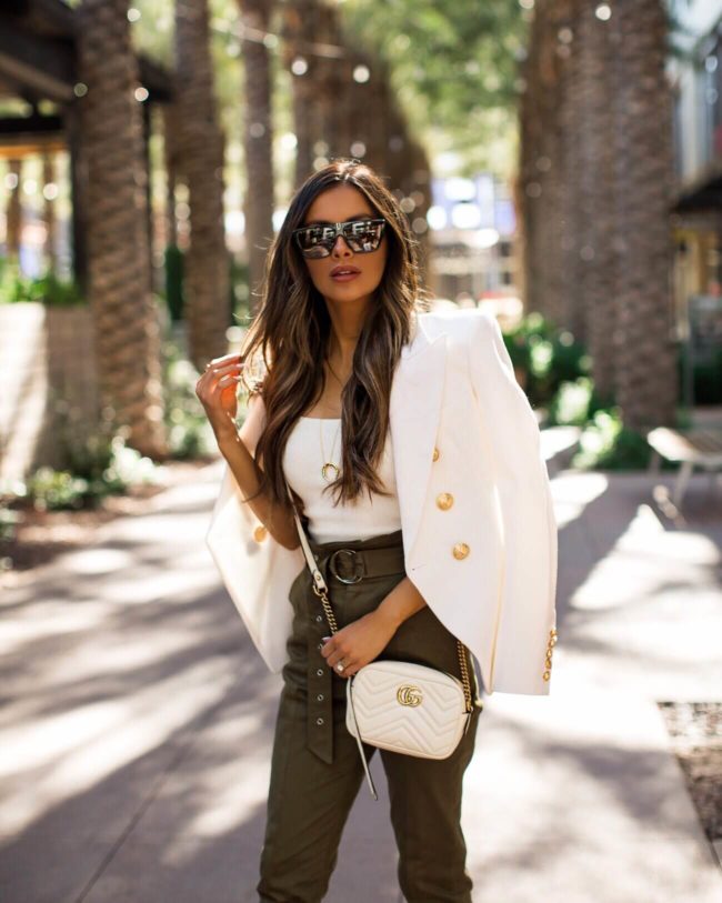 fashion blogger mia mia mine wearing a balmain blazer and revovle paper bag waist pants