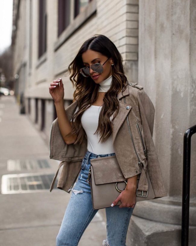 fashion blogger mia mia mine wearing a white bodysuit and blanknyc jacket