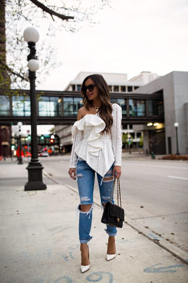 fashion blogger mia mia mine wearing a white off-the-shoulder lace top from saks off fifth
