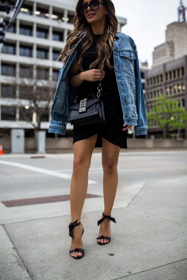 fashion blogger mia mia mine wearing a black knit dress and max studio denim jacket from saks off fifth