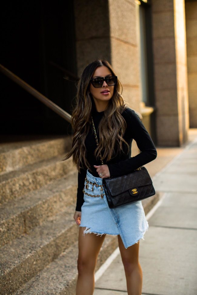 fashion blogger mia mia mine wearing a black bodysuit and a chanel double flap medium bag from ebay