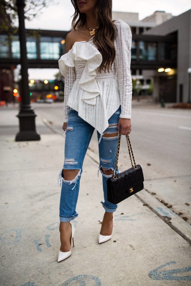 fashion blogger mia mia mine wearing a white off-the-shoulder top from saks off fifth