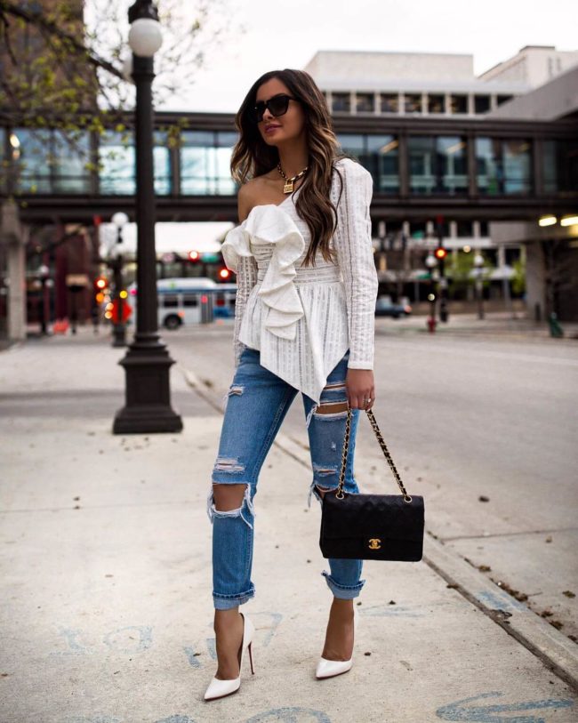 fashion blogger mia mia mine wearing an off the shoulder white ruffle top with a dior lucky locket necklace