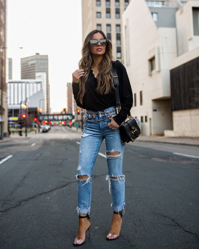fashion blogger mia mia mine wearing a gold chain locket belt from asos and a grlfrnd distressed denim from revolve