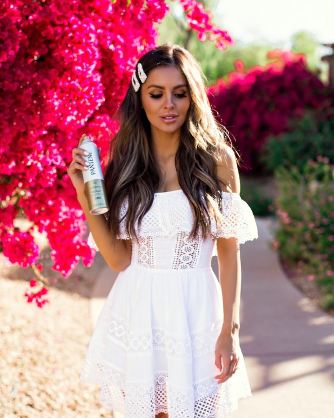 fashion blogger mia mia mine wearing a white lace dress and pearl hair clips
