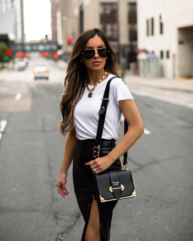 fashion blogger mia mia mine wearing a white tee and a revolve faux leather skirt with a dior lucky locket necklace 2019