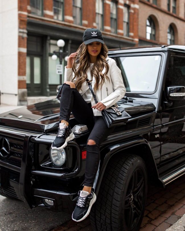 fashion blogger mia mia mine wearing adidas sneakers and an adidas hat from finish line