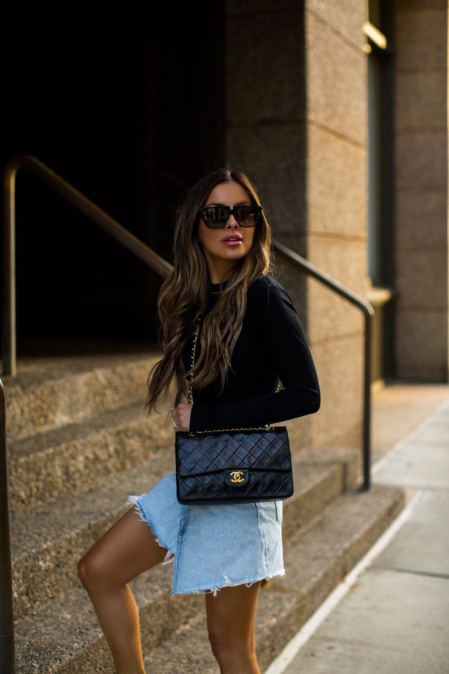 fashion blogger mia mia mine wearing a chanel bag and a gold chain belt