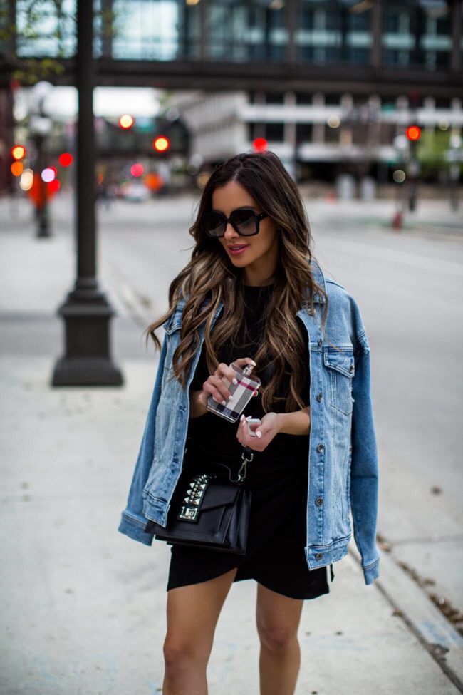 fashion blogger mia mia mine wearing a denim jacket and burberry perfume from saks off fifth