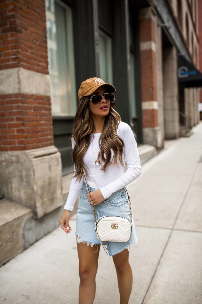 fashion blogger mia mia mine wearing a white tee and carhartt baseball cap from 47 brand