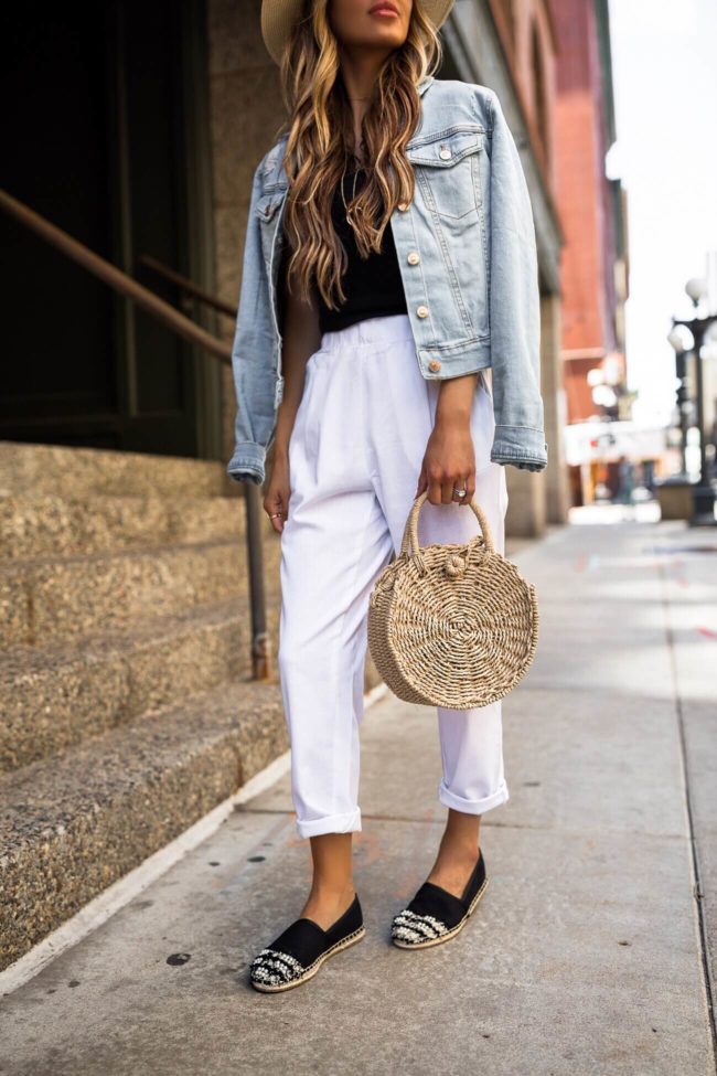 fashion blogger mia mia mine wearing white linen pants and a straw bag from walmart
